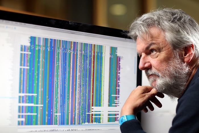portrait photo of Professor Des Higgins looking at a computer screen